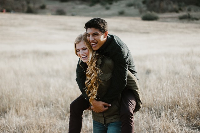 A couple sharing a playful embrace outdoors